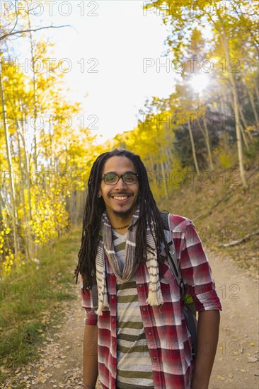 Mixed race man hiking in forest