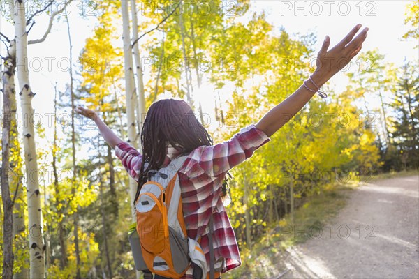 Mixed race man hiking in forest