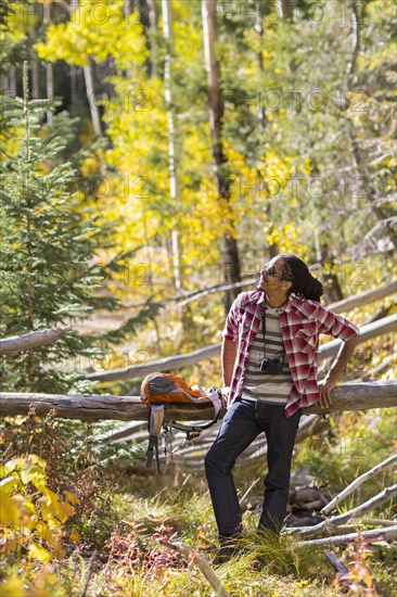 Mixed race man hiking in forest