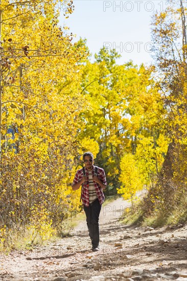 Mixed race man hiking in forest