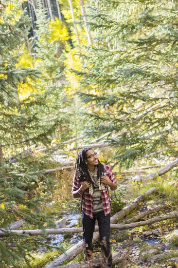 Mixed race man hiking in forest