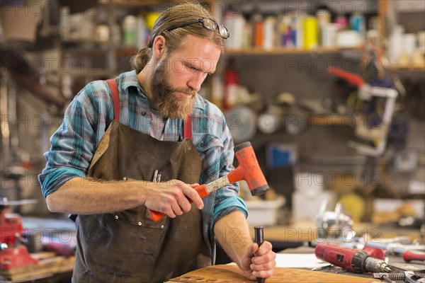 Caucasian craftsman working in workshop