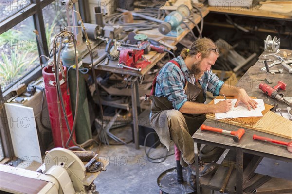 Caucasian craftsman working in workshop