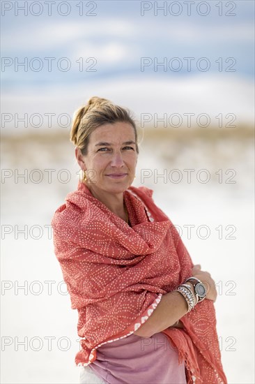 Caucasian woman smiling on sand dune