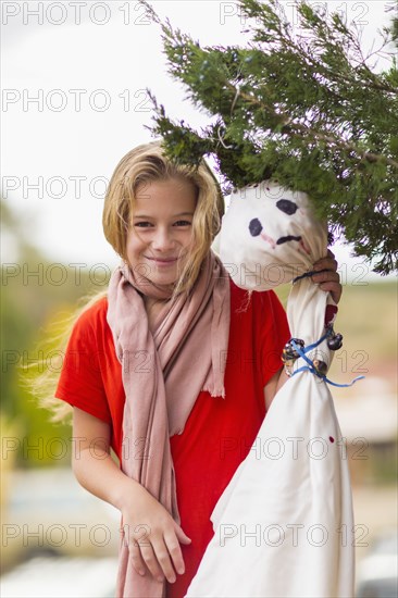 Caucasian girl hanging Halloween decorations