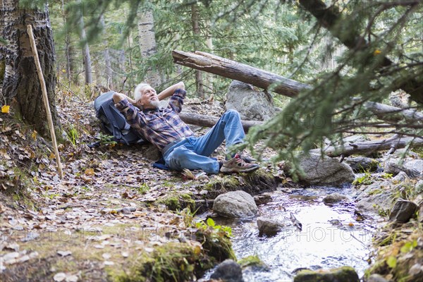 Caucasian hiker resting in forest