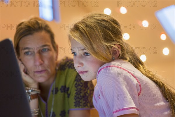 Caucasian mother and daughter using computer together