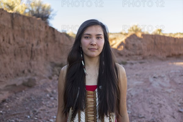 Mixed race woman standing in remote desert landscape
