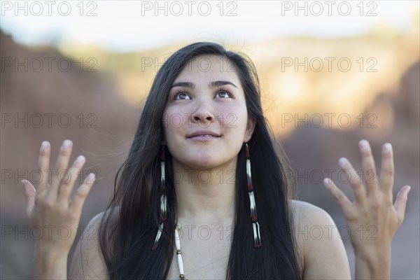 Mixed race woman meditating in desert