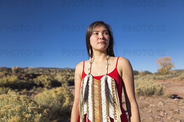 Mixed race woman standing in remote desert landscape