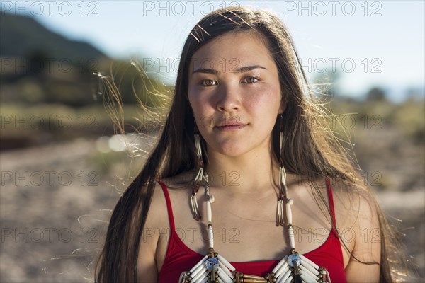 Mixed race woman standing in remote desert landscape