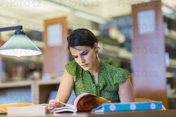 Mixed race student studying in library