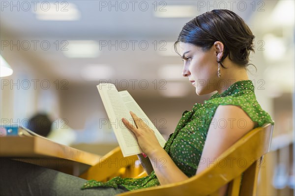 Mixed race student studying in library