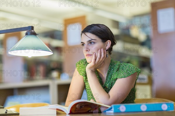 Mixed race student studying in library