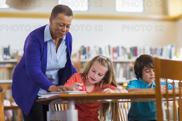 Teacher helping student in classroom