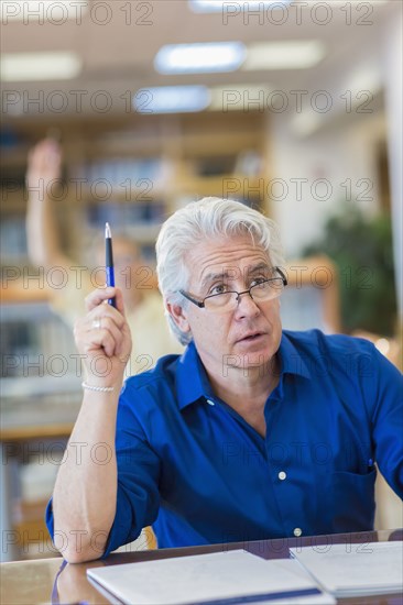 Adult student raising his hand in class