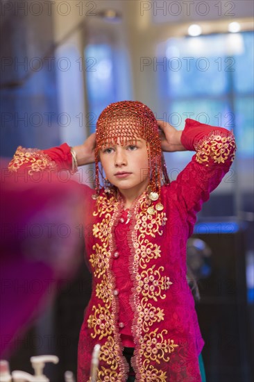 Caucasian girl wearing beaded cap