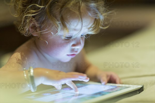 Caucasian baby using digital tablet