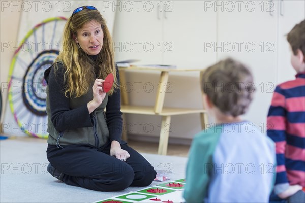 Montessori teacher talking to students in classroom