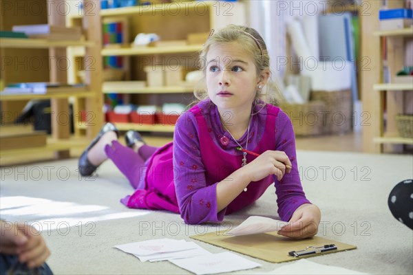 Caucasian girl thinking in classroom