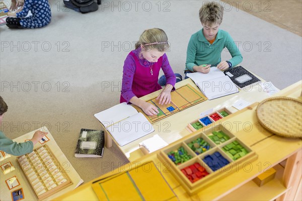 Caucasian children at table in classroom