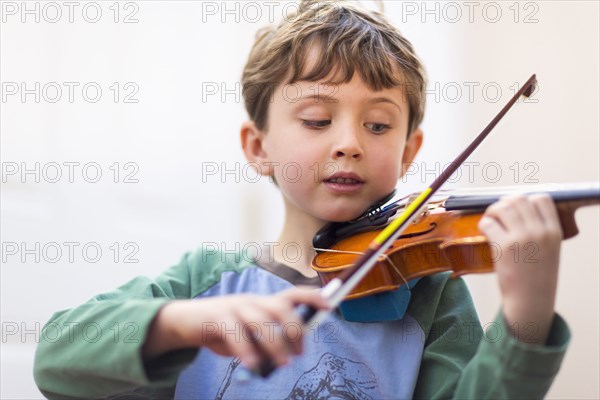 Close up of boy playing violin