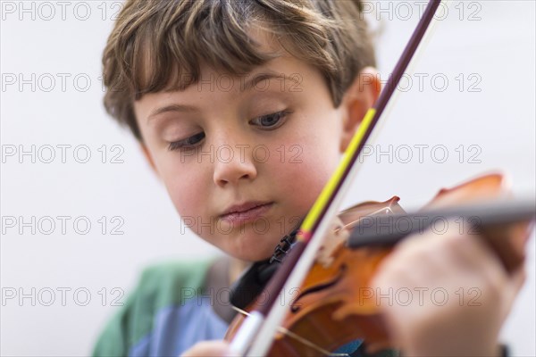 Close up of boy playing violin