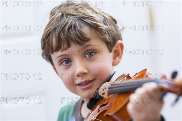 Close up of boy holding violin