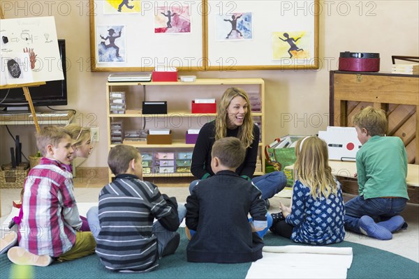 Montessori teacher talking to students in classroom