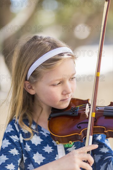 Close up of Caucasian girl playing violin