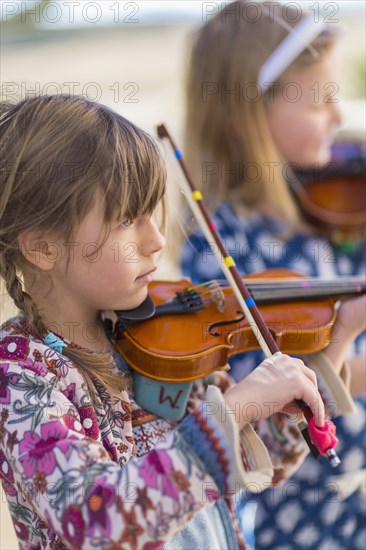 Close up of girls playing violin