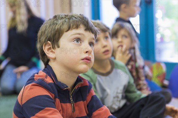 Children sitting and listening in classroom