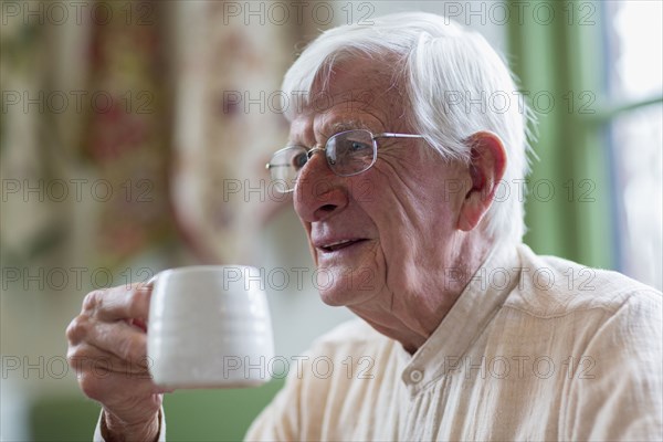 Older Caucasian man drinking coffee