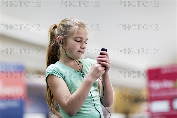 Caucasian girl listening to mp3 player