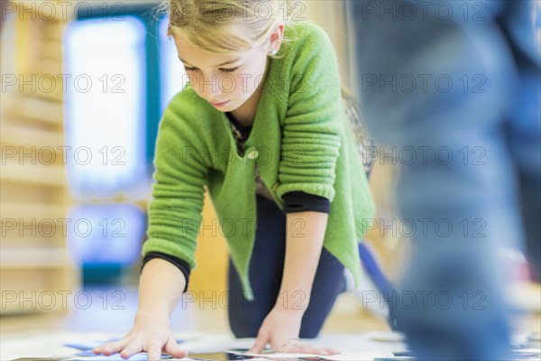 Caucasian girl working in classroom