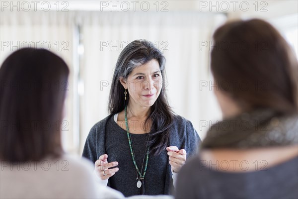 Small business owner talking to customers in store