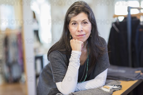 Hispanic small business owner smiling in store