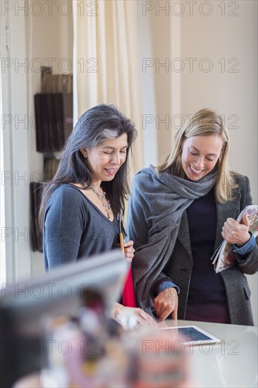 Small business owners using digital tablet in store