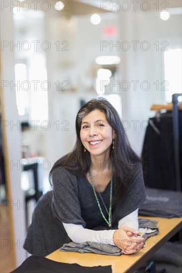 Hispanic small business owner smiling in store