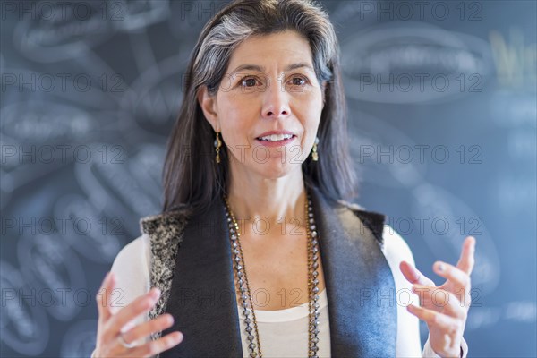 Hispanic businesswoman talking in office