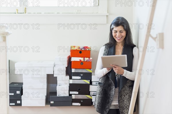 Hispanic woman using digital tablet in office