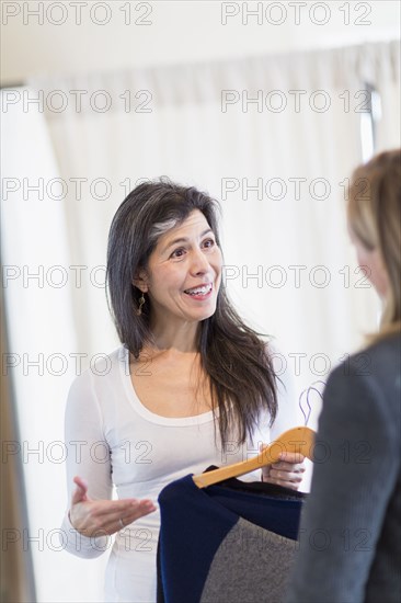 Small business owner talking to customer in store