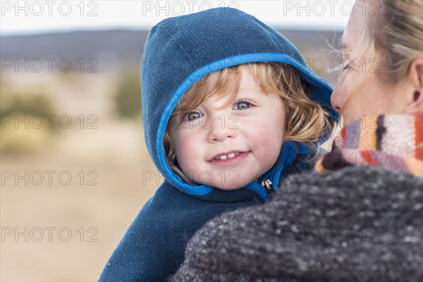 Caucasian mother carrying baby boy