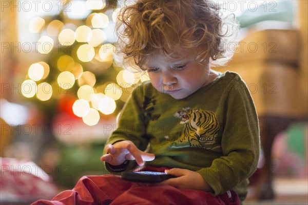 Caucasian baby boy playing with cell phone