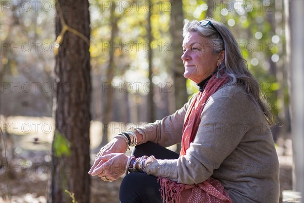 Older Caucasian woman sitting outdoors