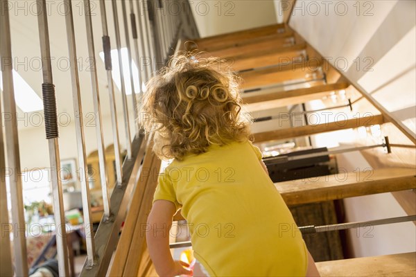 Caucasian baby boy crawling up stairs