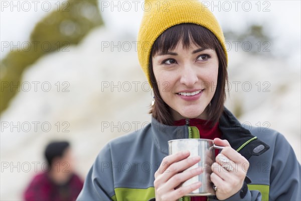 Woman drinking coffee outdoors