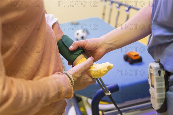 Doctor measuring blood pressure on leg of baby boy