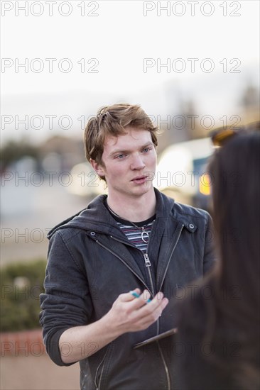 Canvasser talking to woman in city