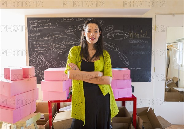 Mixed race businesswoman standing in office